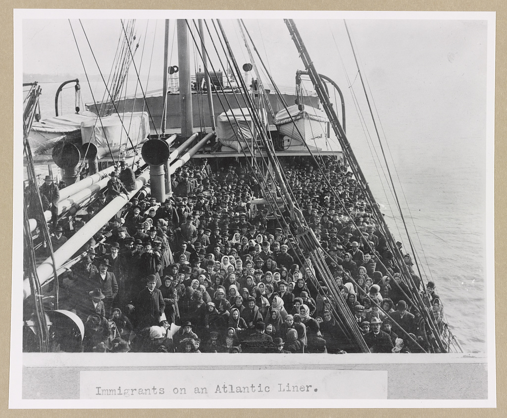 Immigrant family standing on a ship bound for Baltimore