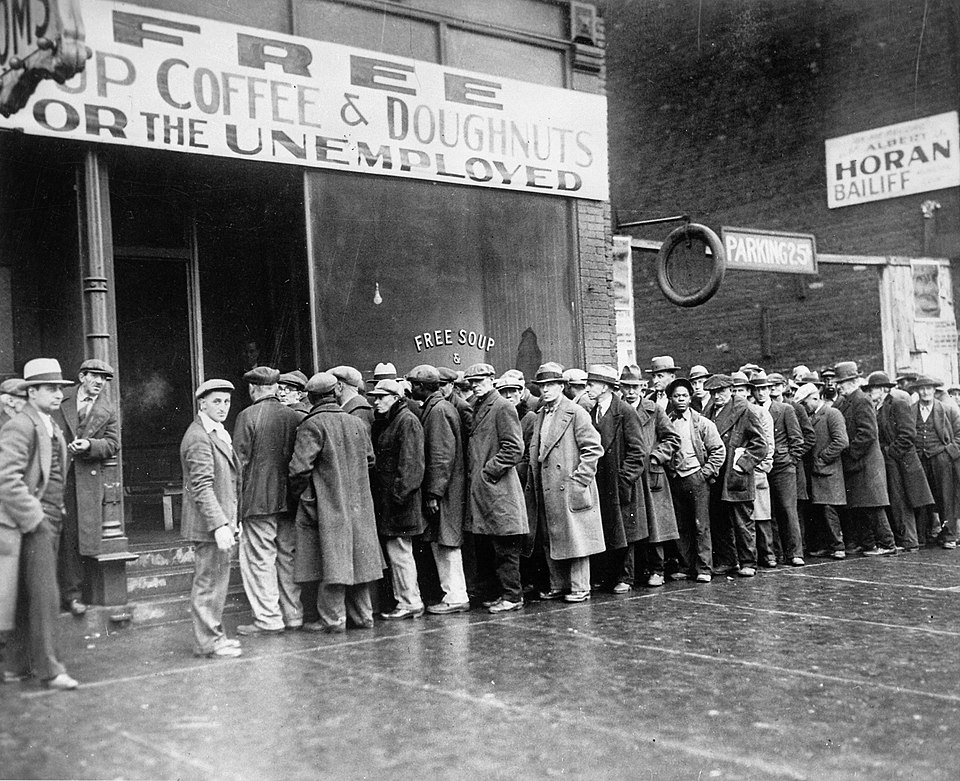 Residents affected by the Great Depression lining the street waiting for free soup and bread