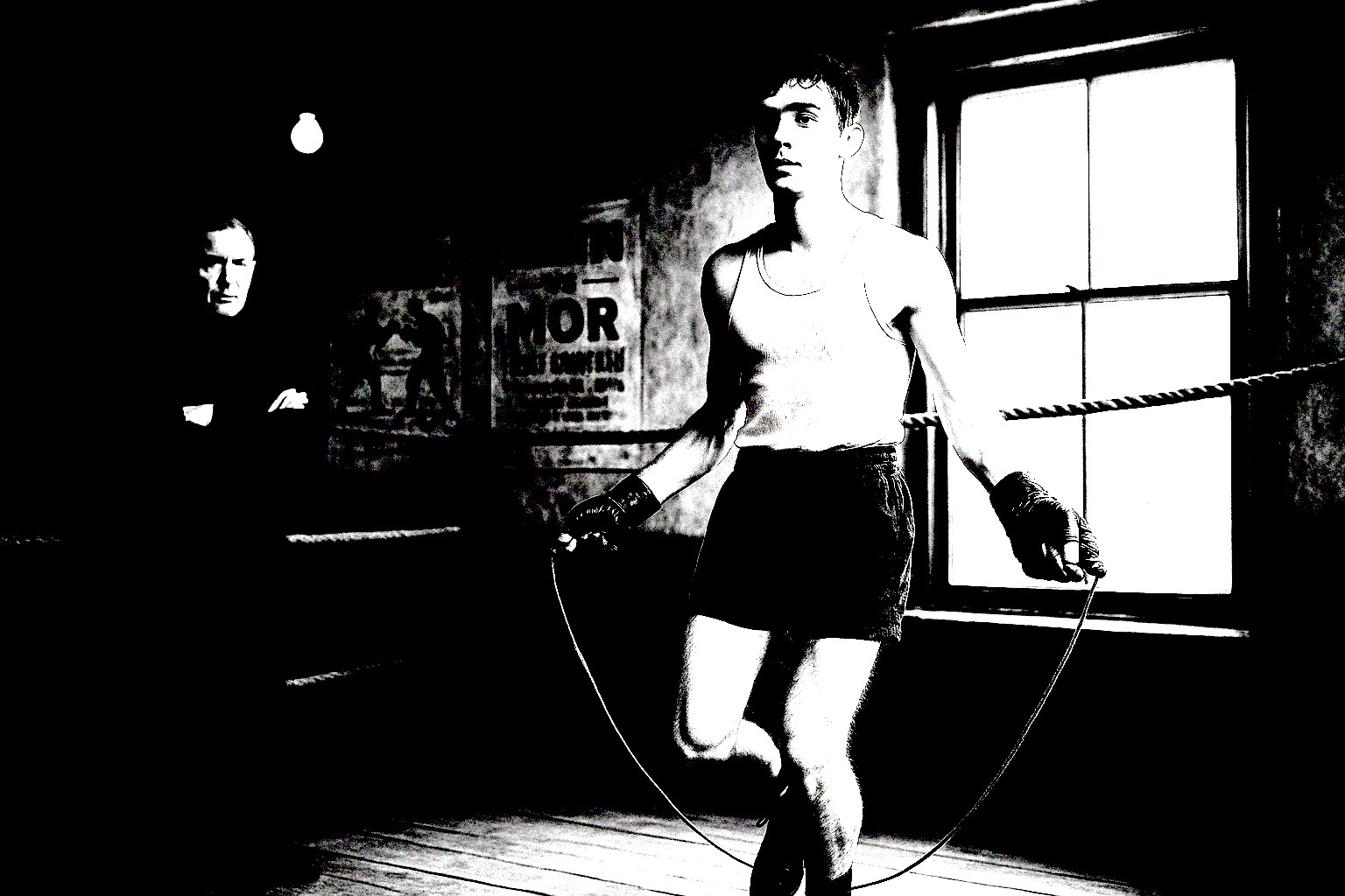 Small 1930s Baltimore boxing crowd watching from wooden benches.